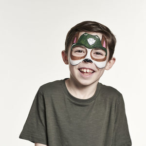 Final step, Filling the centre of the ears with pale pink, outlining the pup with black, painting the nose, adding three dots on either side of the nose, and adding a white highlight to the nose to complete Tracker face paint.