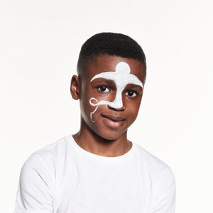 Step one, Using a large round brush, apply classic white in a ghost shape in the centre of the face and over the eyebrows.