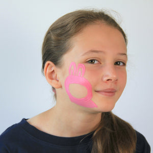 For step 1, use pale pink paint to draw the shape of your furry monster and fill it all in except for the face and ears.