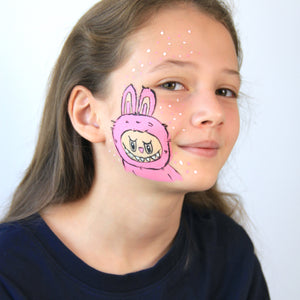 For Step 3, use black, pale pink and white paint to draw an outline around your Monster and then add the finishing touches of eyes, nose, teeth and a few dots around the face. Cute but scary furry Monster complete!