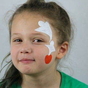 Step one, Painting the pumpkin on the cheek with orange paint, then painting the ghosts coming out of the pumpkin across the forehead.